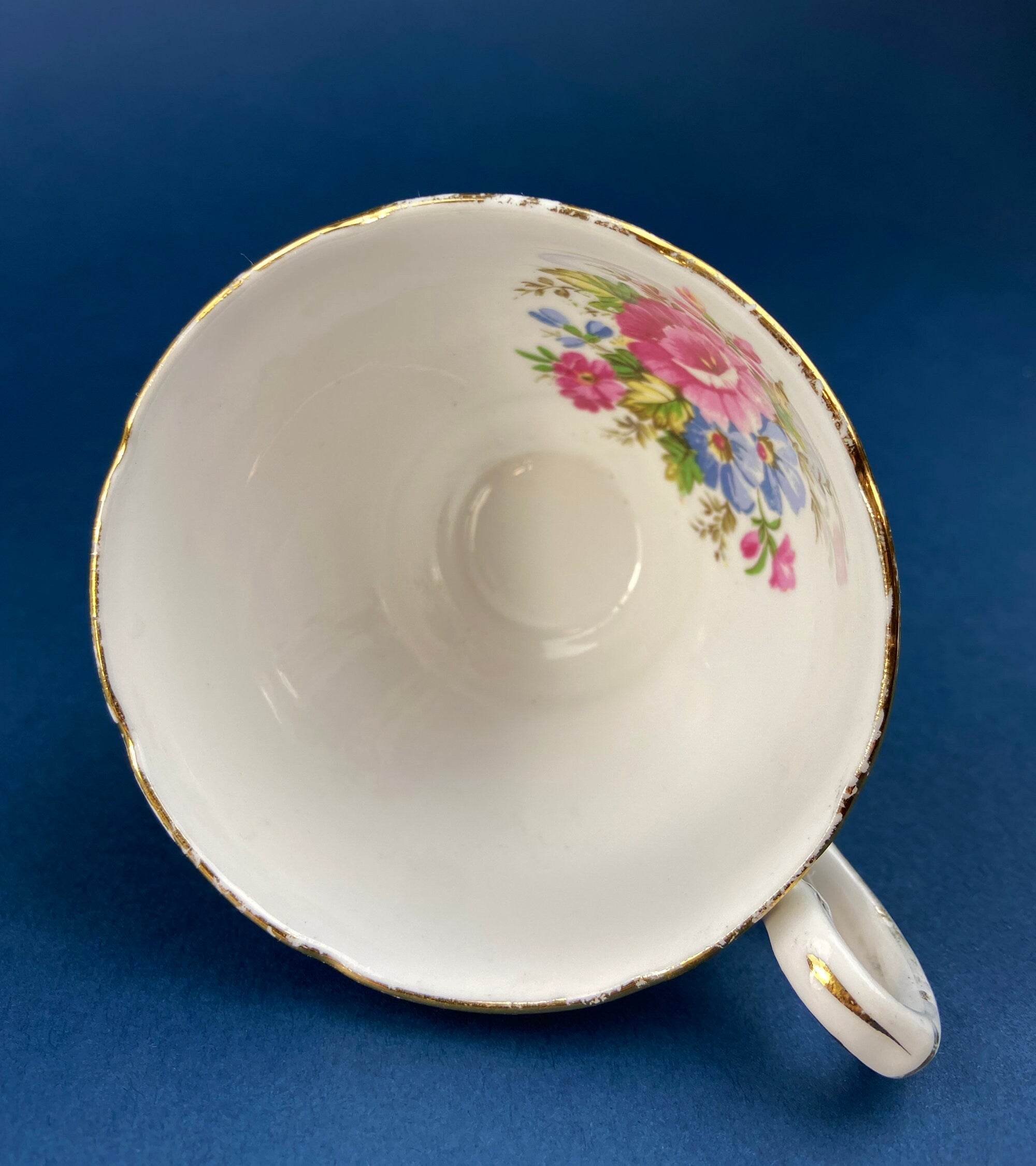 Royal Stafford Cup and Saucer. Black with Gold. Hand Painted Flower Bouquet Inside of Cup and on the Plate.