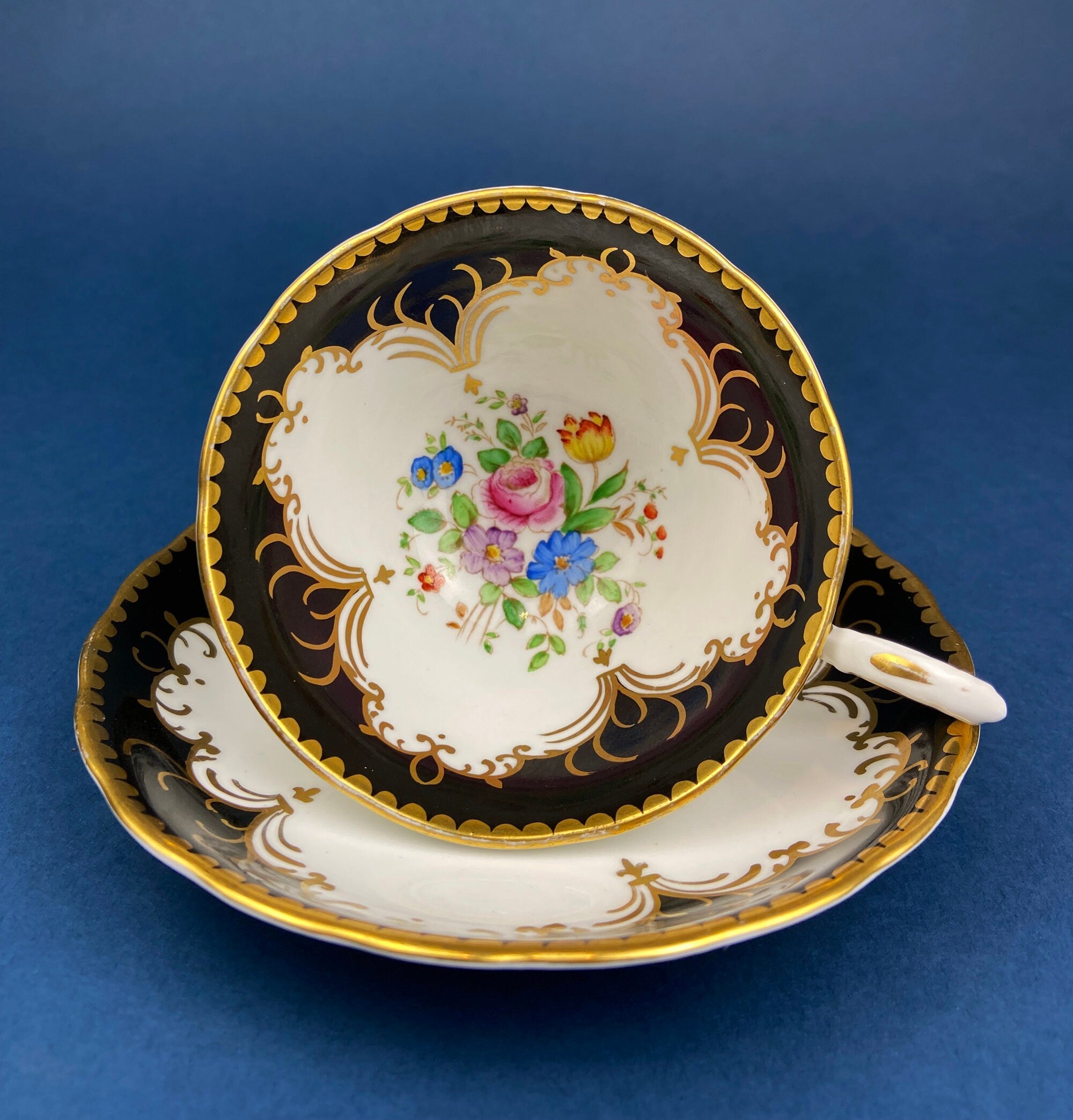 Royal Stafford Cup and Saucer. Black with Gold. Hand Painted Flower Bouquet Inside of Cup and on the Plate.