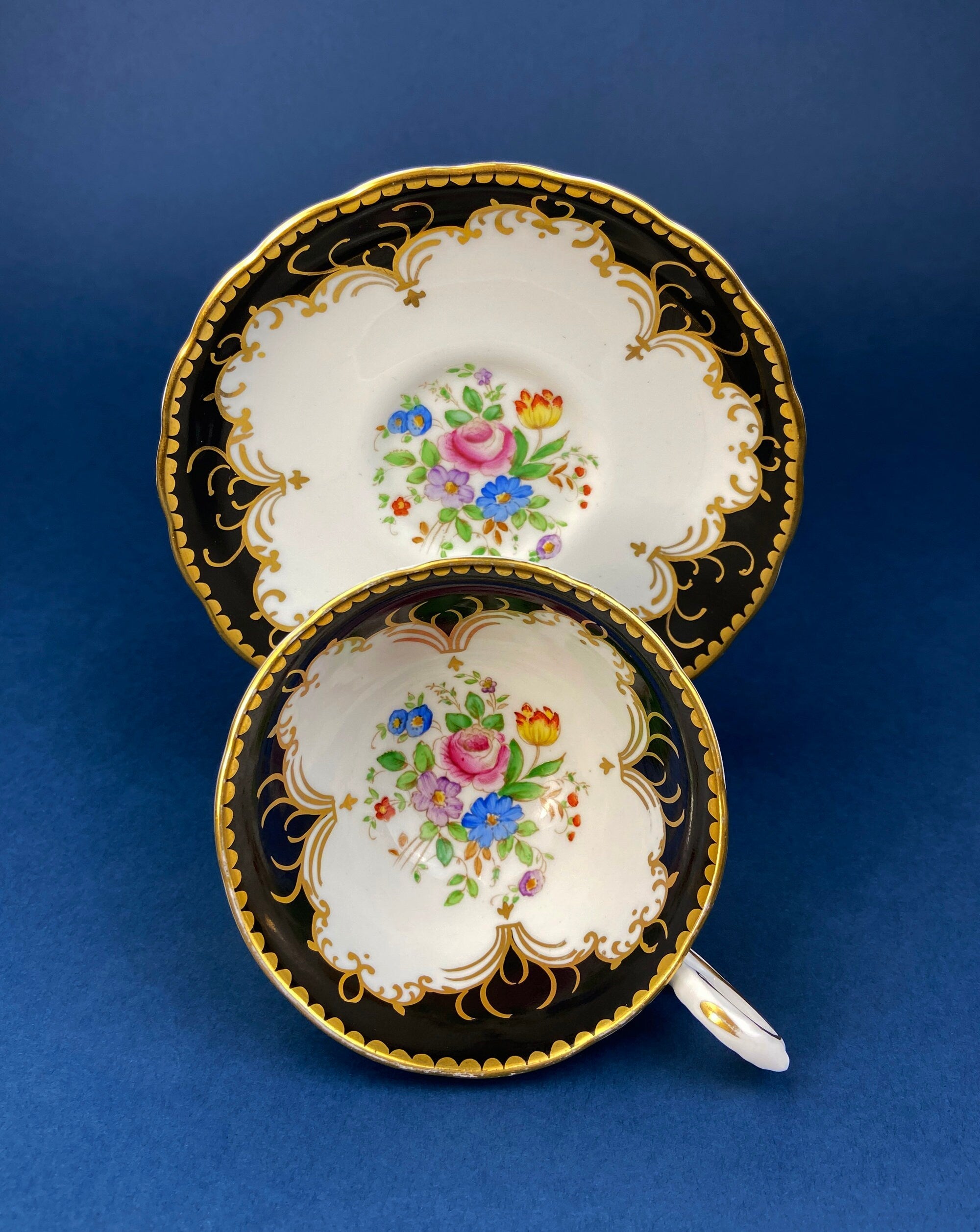 Royal Stafford Cup and Saucer. Black with Gold. Hand Painted Flower Bouquet Inside of Cup and on the Plate.