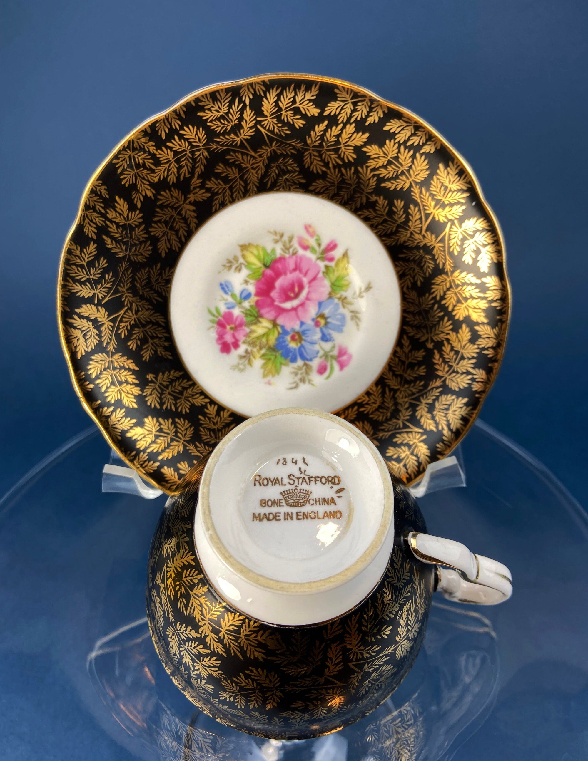 Royal Stafford Cup and Saucer. Black with Gold. Hand Painted Flower Bouquet Inside of Cup and on the Plate.