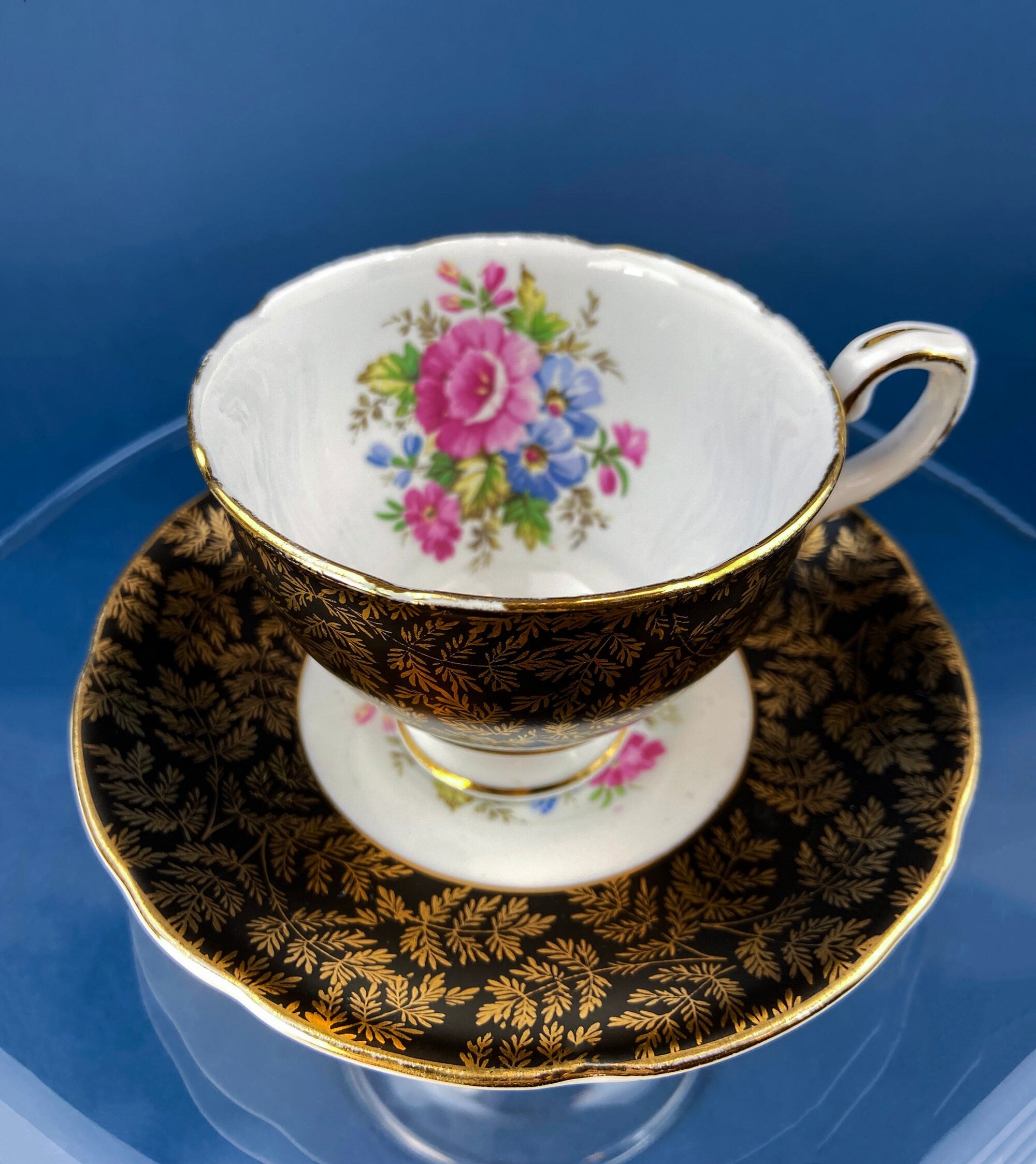 Royal Stafford Cup and Saucer. Black with Gold. Hand Painted Flower Bouquet Inside of Cup and on the Plate.