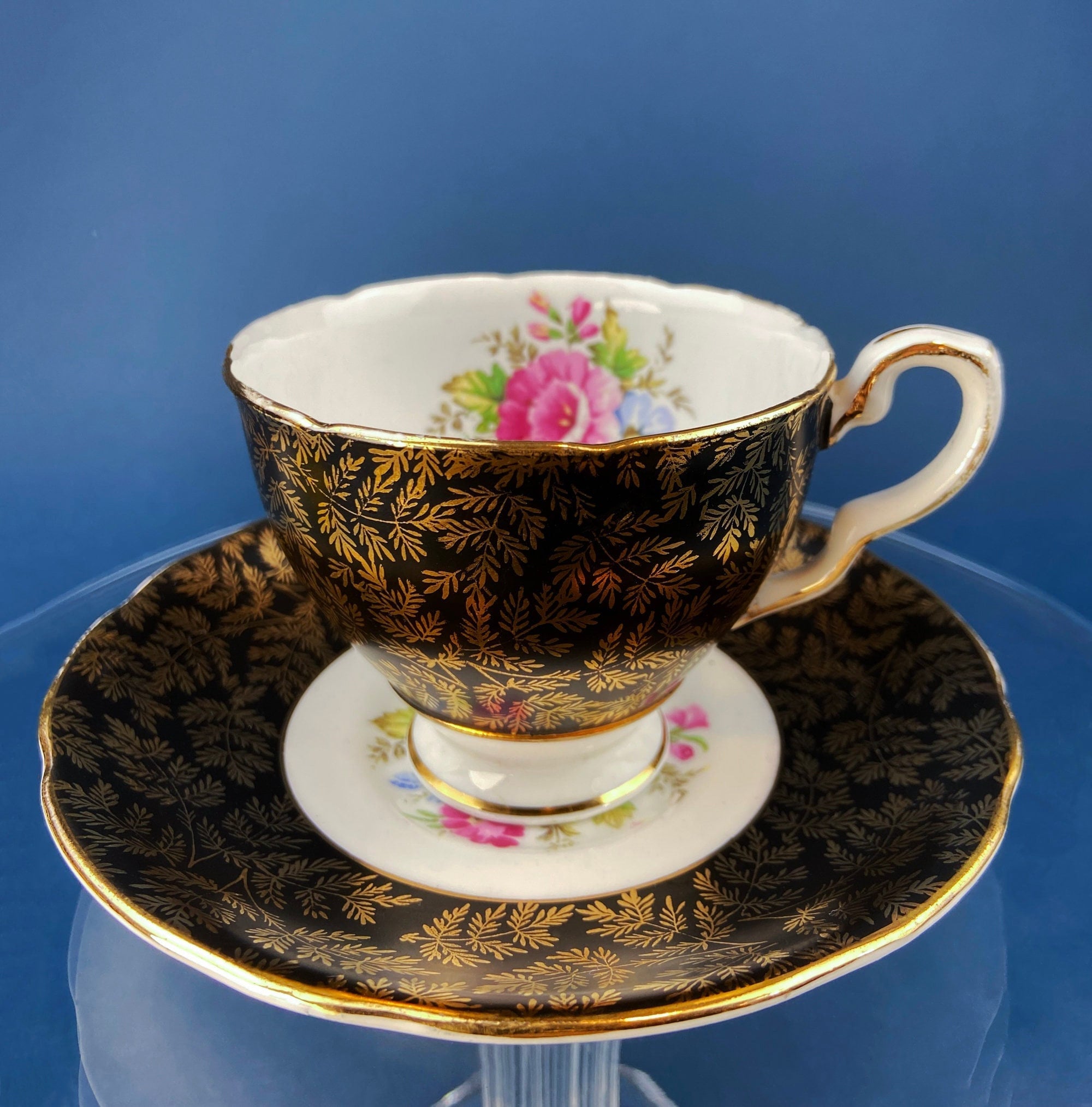 Royal Stafford Cup and Saucer. Black with Gold. Hand Painted Flower Bouquet Inside of Cup and on the Plate.